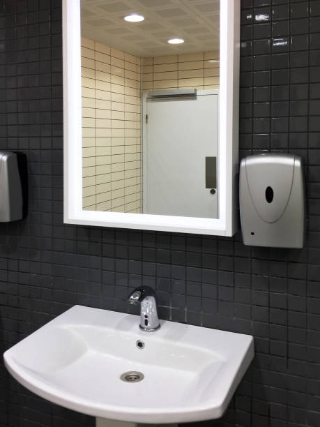 istock Public restroom mirror faucet and sink 1313911028