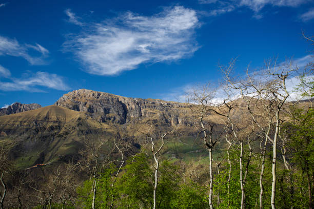 Panoramic view of Table Mountain in Ingushetia, Russia. Mountain landscape, rocks, plateau and blue sky. The road to the top. Mountain climbing. Tourist adventure.