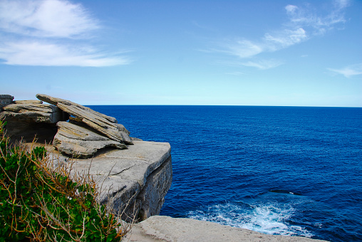 Beautiful view looking out to sea from a rocky overhang along the eastern coast of Australia near Bondi Beach.