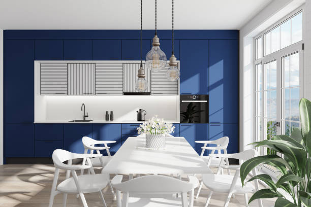 Naval blue and white Modern Scandinavian kitchen with large dining table and chairs. Large windows. Open space kitchen concept. Summer scene.