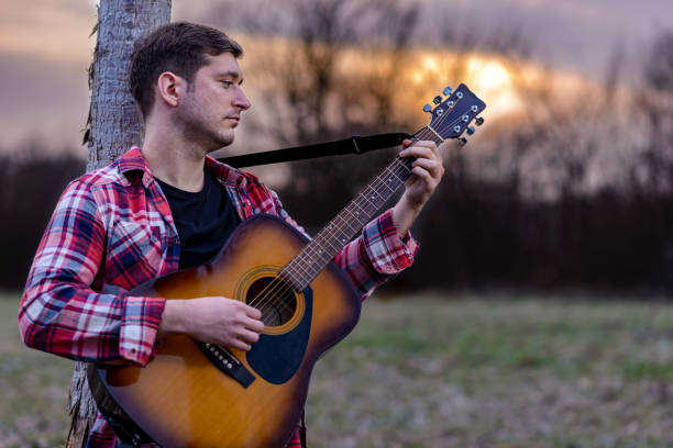 istock Man playing classical acoustic guitar 1313916710