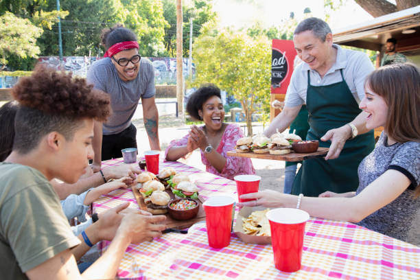 istock Friends having fun and eating outside 1313917704
