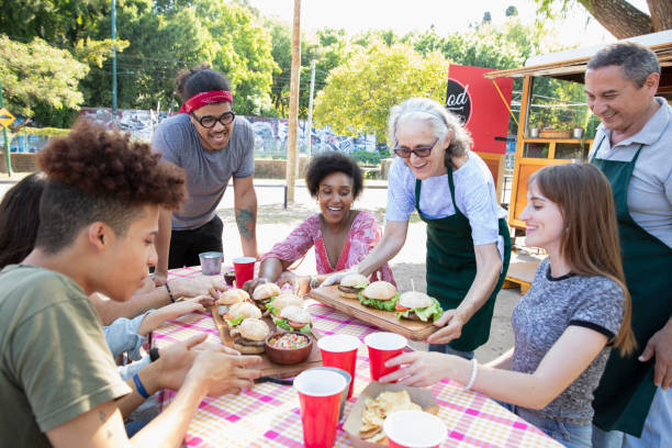 istock Friends having fun and eating outside 1313917707
