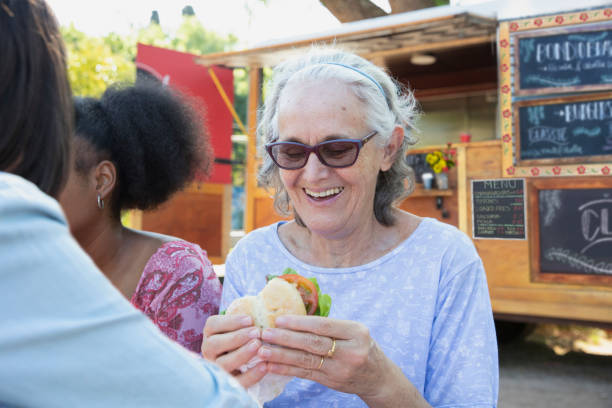 istock Friends having fun and eating outside 1313917715