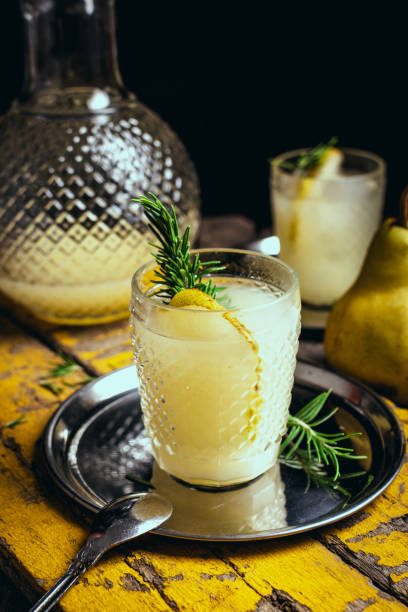 glass of pear juice and rosemary on a wooden board. Still life photography. dark style. vertical photography for social media glass of pear juice and rosemary on a wooden board. Still life photography. dark style. vertical photography for social media perfect pear stock pictures, royalty-free photos & images