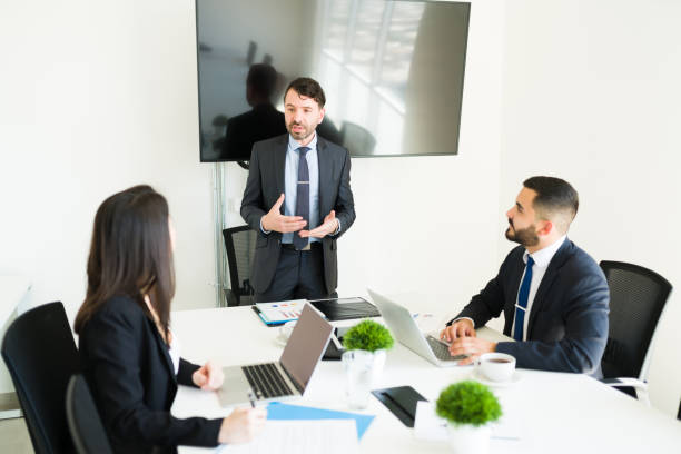istock Businessman giving a pep talk to his work team 1313919436