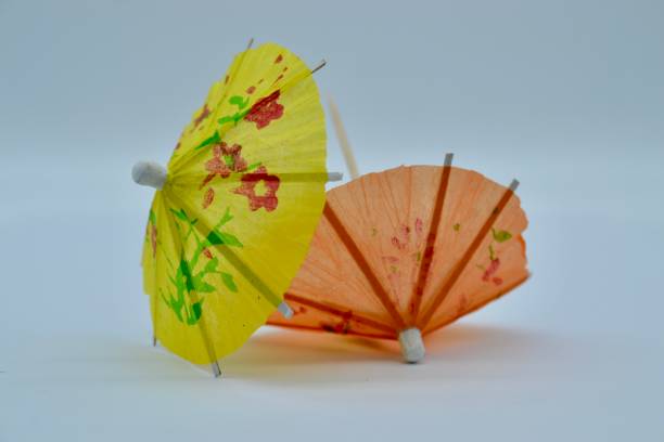 istock Discarded cocktail drinks umbrellas after a party on white background 1313921022