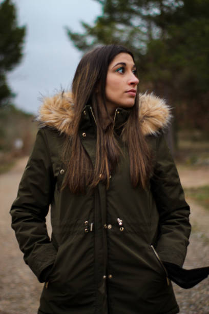 istock Vertical young and beautiful woman on an excursion and walk in a forest 1313921793