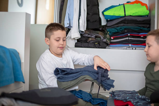 istock Children sorting clothes from their closet for donation 1313921836