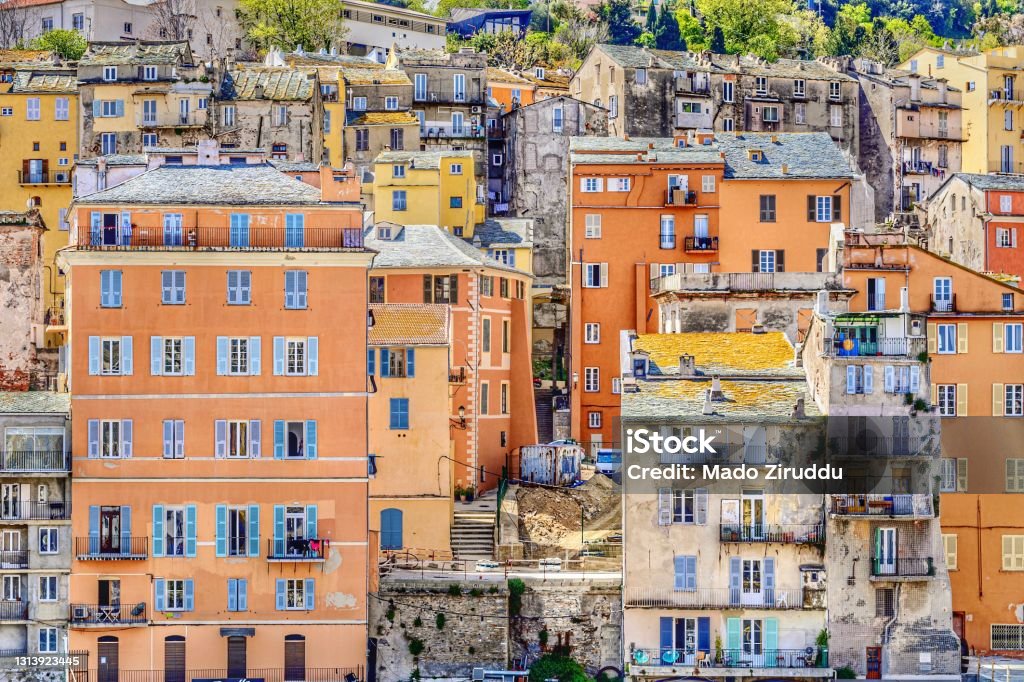 Mediterranean colorful facades in Basti, Corsica Charming atmosphere of the oldest part of the city of Bastia, with colored facades, stoned roofs, wooden shutters Bastia Stock Photo
