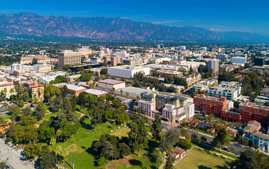 Downtown Pasadena Aerial Skyline View with the San Gabriel Mountains in the background and Central Park in the foreground.  Pasadena is a suburb and satellite city of the city of Los Angeles.