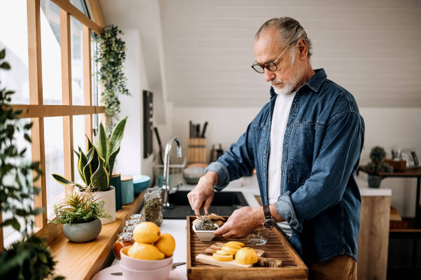 istock Senior man making cup of tea at home 1313928443