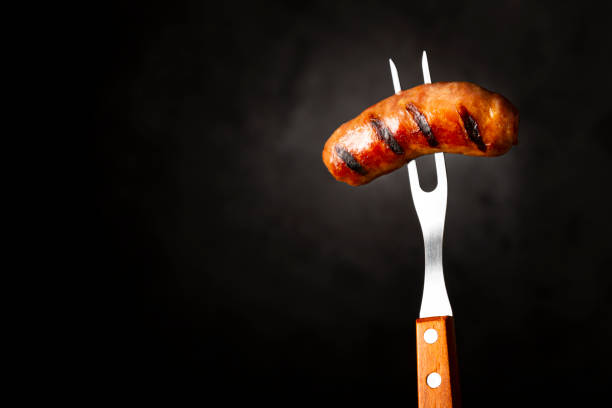 istock Grilled sausage skewered on the fork. Brazilian barbecue. 1313932261