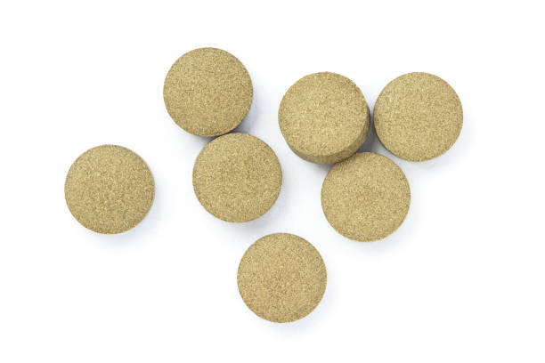 istock Green natural herbal medicine tablet pills isolated on white 1313945982