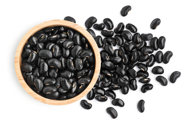 istock black beans ( Urad dal, black gram, vigna mungo ) in wooden bowl isolated on white 1313946023