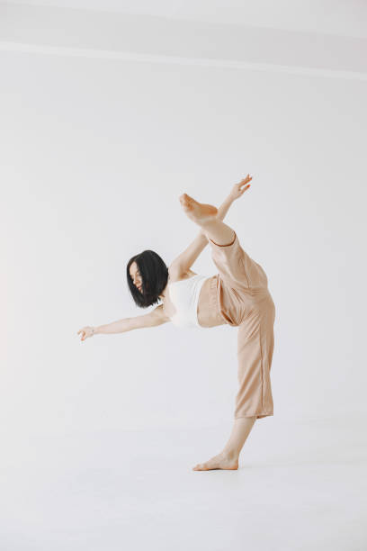 istock Beautiful young woman dancing in studio 1313946605