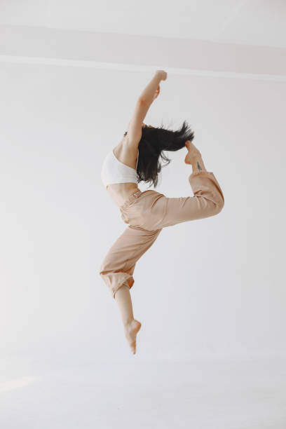 istock Beautiful young woman dancing in studio 1313946619
