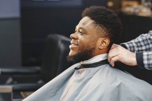 istock Young African-american man visiting barbershop 1313946752