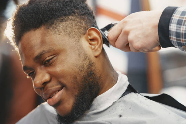 istock Young African-american man visiting barbershop 1313946799
