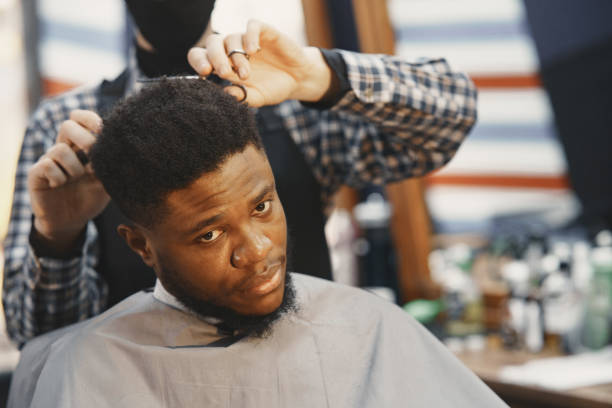 istock Young African-american man visiting barbershop 1313946861