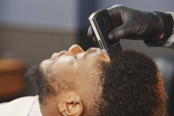 istock Young African-american man visiting barbershop 1313946949