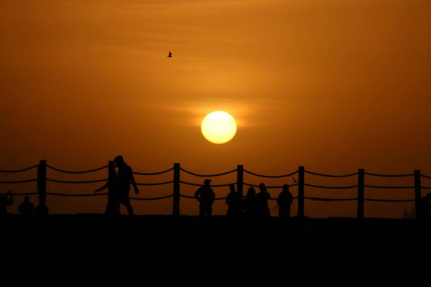 Silhouette of people at sunset at the Dubai's kite beach in the united arab emirates