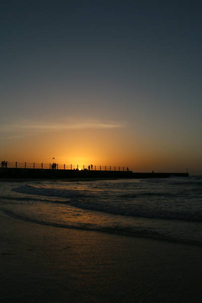 Silhouette of people at sunset at the Dubai's kite beach in the united arab emirates