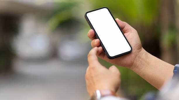 istock Male hands using smartphone include clipping path screen in blurred outdoor background 1313950014