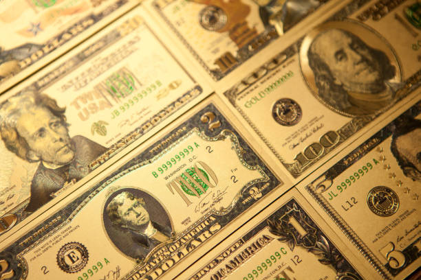 istock Currency US golden dollar banknotes close-up background. 1313951946