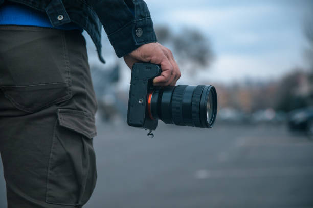 istock man holding camera in street 1313952976