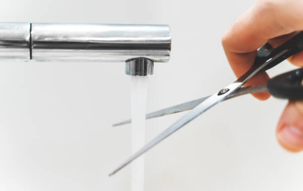 istock Cutting water with scissors. The concept of useless actions. 1313953271