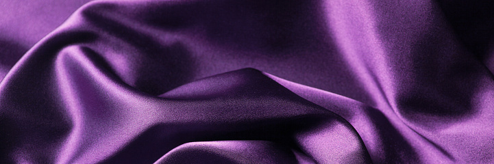 Abstract background luxury cloth or liquid wave or wavy folds of silk texture satin material. Purple background for banner design.
