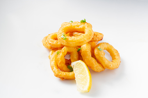 Fried squid on white table with lemon. selective focus. copy space