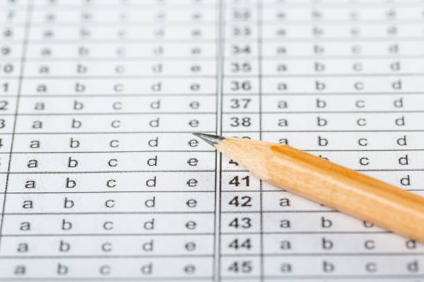 istock testing in exercise and exam paper. computer sheet with pencil in school test room, education concept 1313958526
