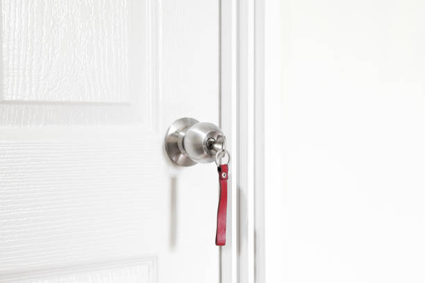istock Installing locking knob with key at the door inside the house 1313959234