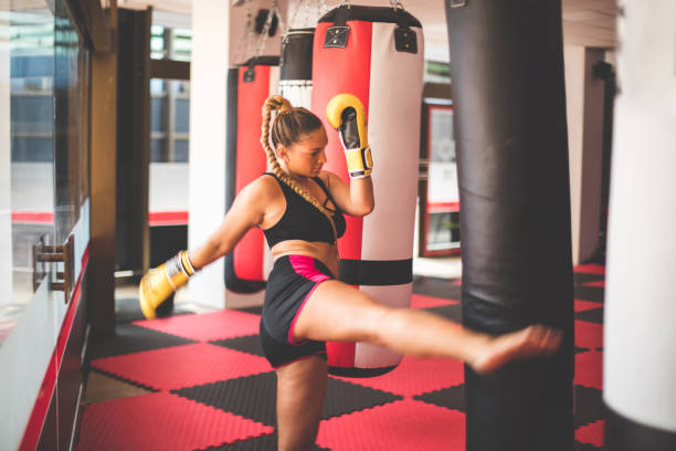 istock Strong young lady, punching bag in gym alone. 1313959484