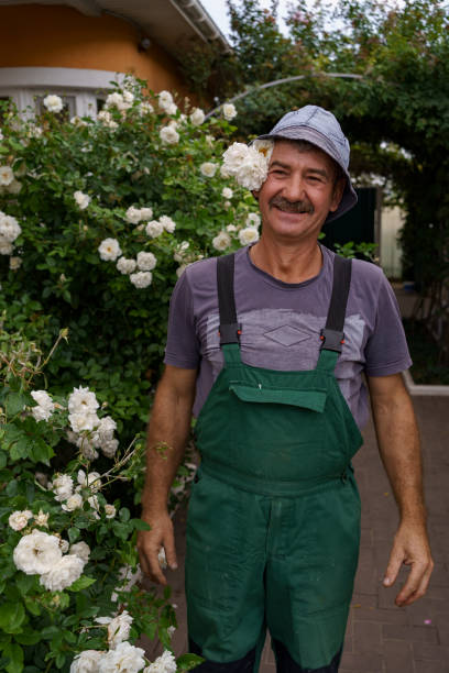 istock Portrait smiling man with white roses 1313959487