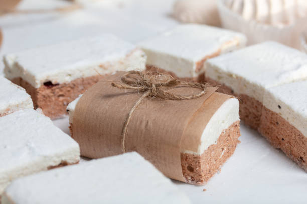 istock Portion marshmallow with cocoa and cranberries. Wrapped in paper and tied with string. Two-layer zephyr. 1313960575
