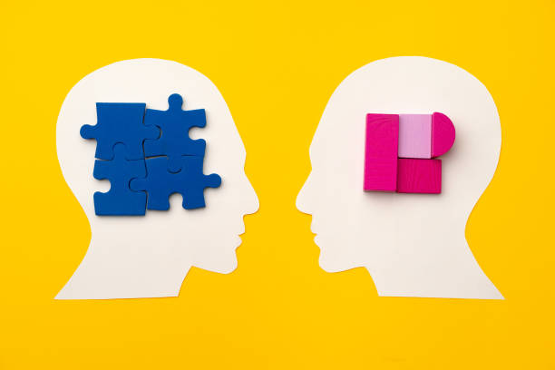 istock Papercut head silhouette with puzzle pieces on yellow background 1313960796