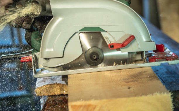 istock Worker carpenter is sawing a wooden Board with a hand-held circular saw 1313961403