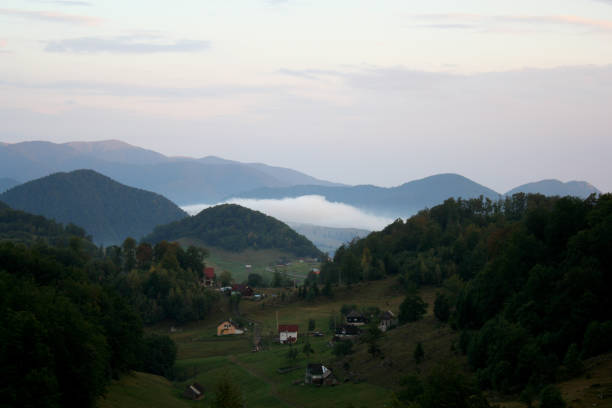 istock Valley with mountain behind in fog 1313961634