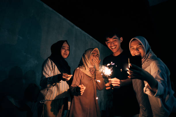 istock Lovely Group of Muslim Playing Fireworks Celebrating Eid Mubarak 1313964839