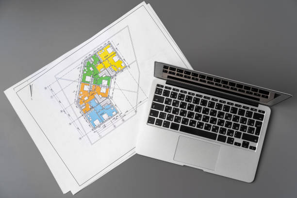 istock Working table of interior designer with blueprint and laptop 1313967349