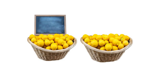 organic lemons in wooden basket organic lemons in wooden basket on isolated background, front view. black blank blackboard on wooden basket healthy eating vegetarian food studio shot stock pictures, royalty-free photos & images