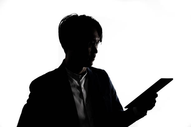 istock Silhouette of businessman use tablet isolate on  white background. 1313972129