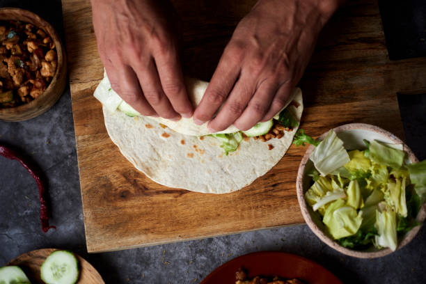 istock a young man is rolling a durum or a burrito 1313974556