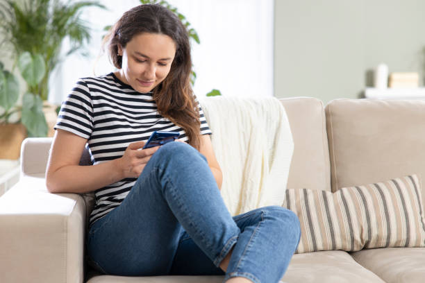 istock Young woman using phone at home 1313975191