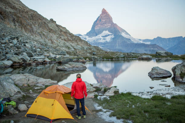 istock Man camping on mountain top, sunrise 1313976531