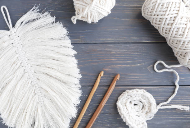 istock Macrame-style sheet on a gray wooden background with space for text, handmade, needlework, knitting. Home decor. 1313977709