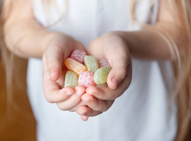 istock Child holding candy,  jelly in hand 1313978656